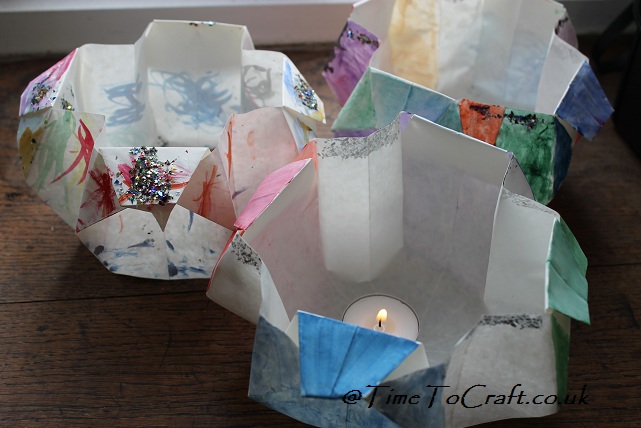 origami lanterns with candles lit