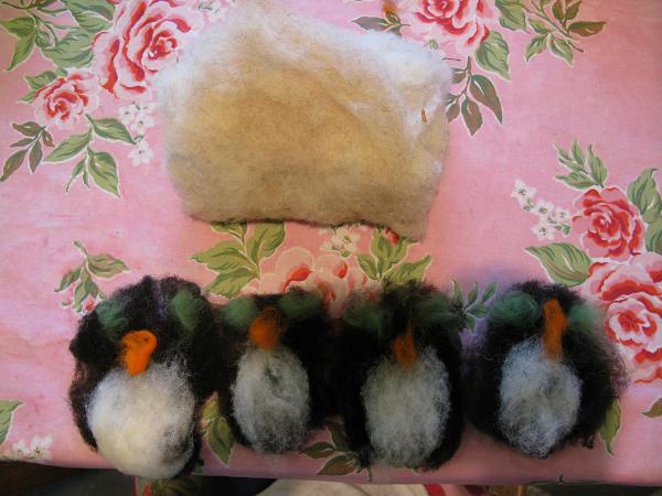 Four penguins waiting to be felted to the case.