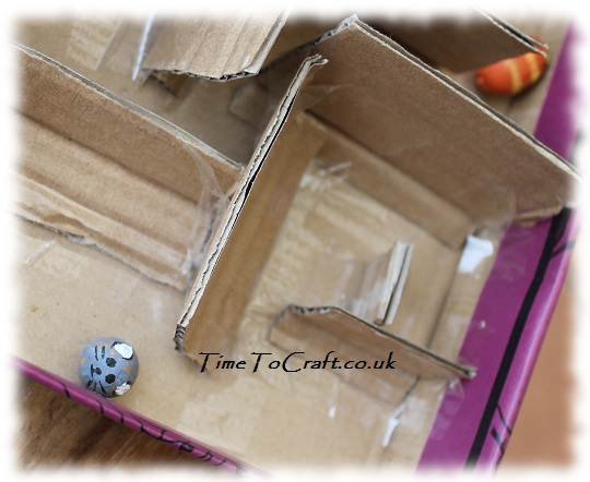 cat acorn and mouse in cardboard maze