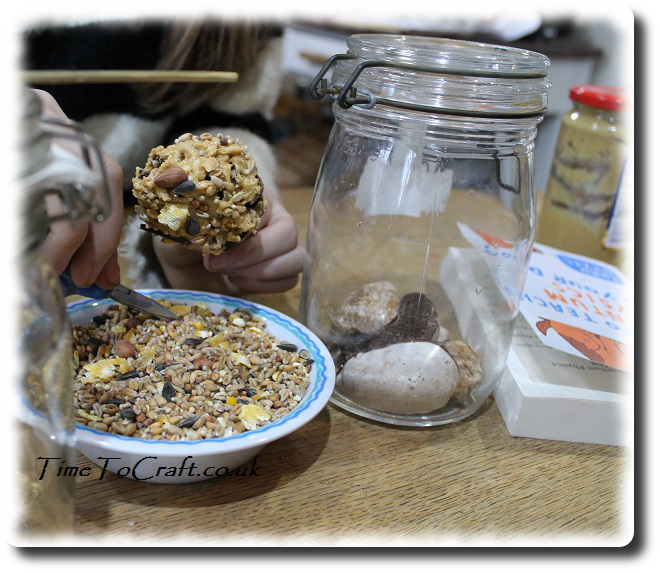 making peanut and seed bird feeders using pine cone