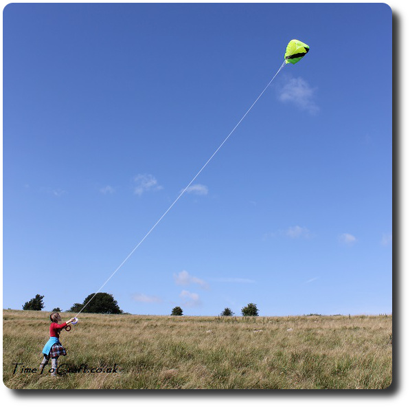 kite flying up high by child