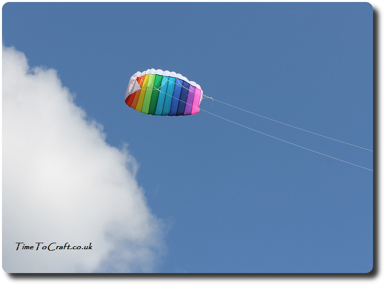 rainbow kite against blue sky