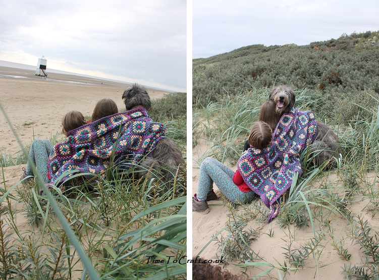 sisters and dog on the beach with crochet blanket