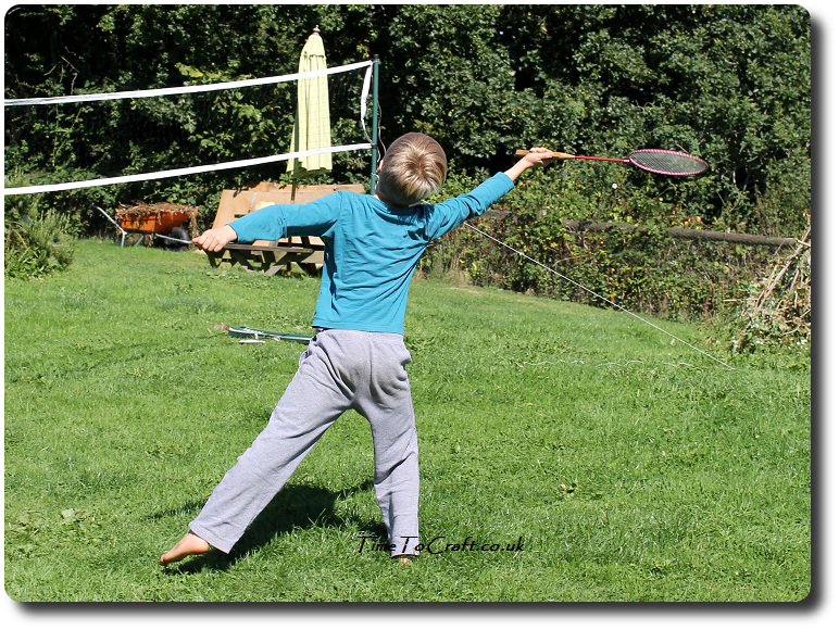 T playing badminton in the garden 2