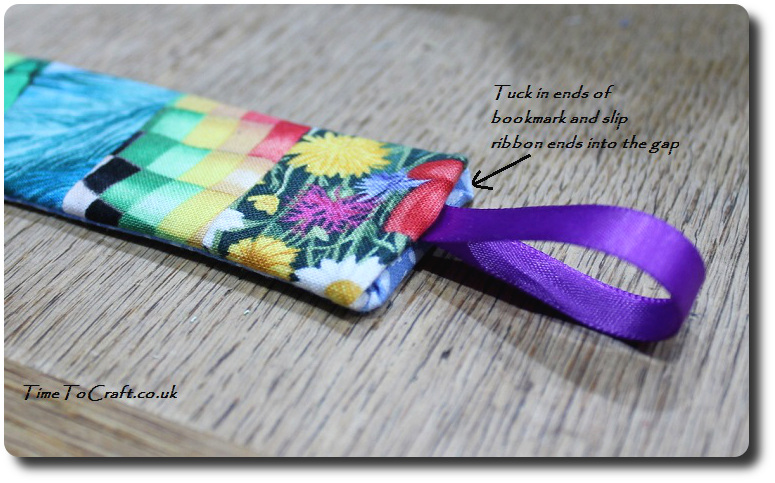 adding a ribbon to the fabric bookmark