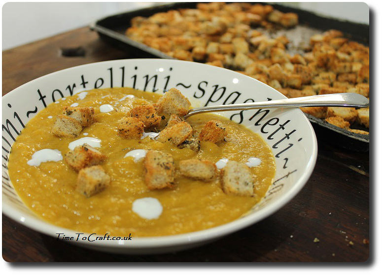 Croutons in a bowl of pumpkin soup using leftover bread