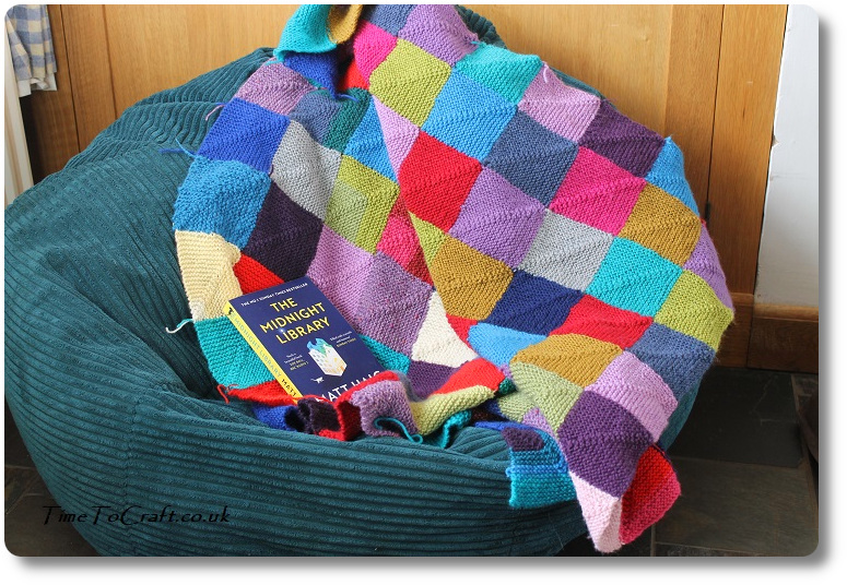 knitted blanket draped on beanbag