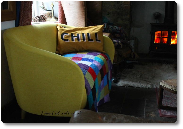 Yellow sofa by the fireplace